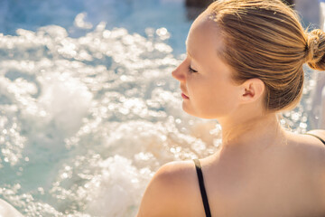 Portrait of young carefree happy smiling woman relaxing at hot tub during enjoying happy traveling...