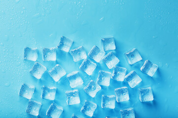 Ice cubes with water drops scattered on a blue background, top view