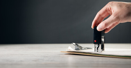 the man puts a seal on the document