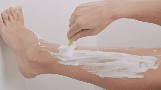b roll female legs depilation holding razor with perfect body beauty routine at home