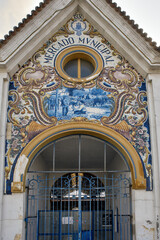 Typical Portuguese Azulejos or Blue tiles with traditional rural scenes, on the facade of Mercado...