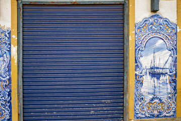 Typical Portuguese Azulejos or Blue tiles with traditional rural scenes, on the facade of Mercado...
