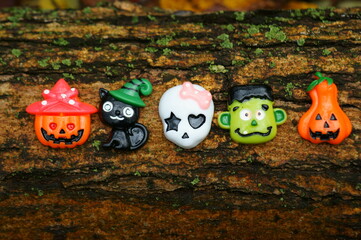 Toy decorations for Halloween on the background of tree bark.