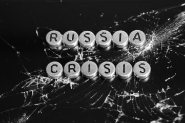 The inscription Russia, crisis on the background of broken glass. Black and white photo.