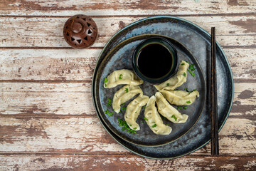 Gyoza or dumplings snack with soy sauce, selective focus, copy space.and chopsticks, top view.