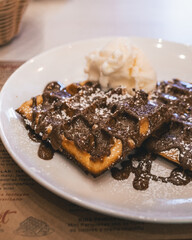 waffle with chocolate topping and whipped cream