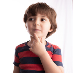 Fototapeta premium little boy making funny expressions and posing with many faces and thinking 