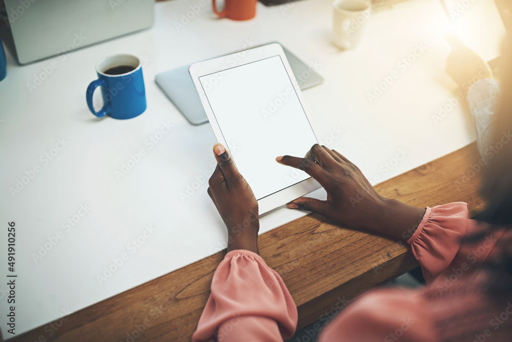 Poster Getting business done the smart way. Shot of an unrecognisable businesswoman using a digital tablet in an office.
