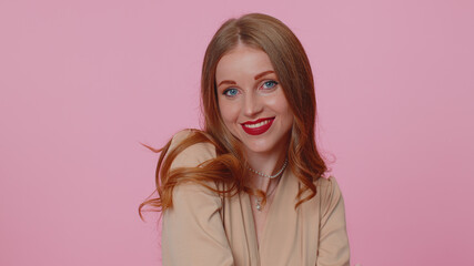 Cheerful beautiful businesswoman student girl in beige blouse smiling and looking at camera. Young fashion lovely model woman indoors studio shot isolated on pink wall background. Female nature beauty