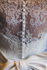 Fototapeta na wymiar Close up white classic wedding dress tiny flowers ornaments with buttons set