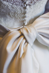 Close up of an elegant wedding dress with big bow