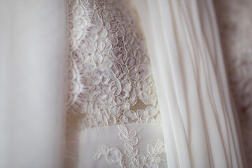 Close up view white flowers pattern on white wedding dress. Classic wedding dress styles concept