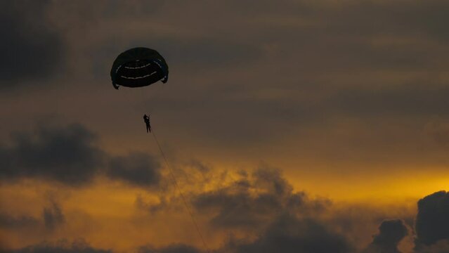 Parachute flight at sunset