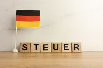 Word steuer which means tax in German and flag of Germany
