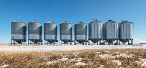 A row of grain storage bins on the Canadian Prairies