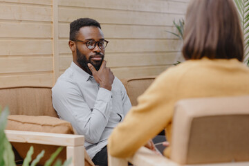 a male psychologist conducts a patient's appointment in an office or a medical center. African...