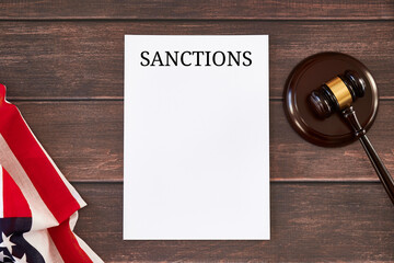 US sanctions list, American flag and judge's gavel on wooden table.