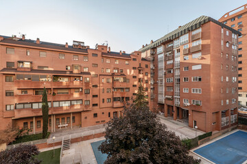 Interior facades of urban residential buildings with covered swimming pools and gardens with trees