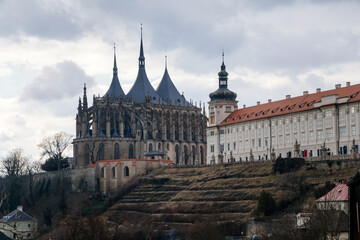 Fototapeta na wymiar Kutna Hora, Central Bohemian, Czech Republic, 5 March 2022: St. Barbara's Church with lancet windows, Unique gothic stone cathedral and Former Jesuit College, baroque statues, arches and buttresses