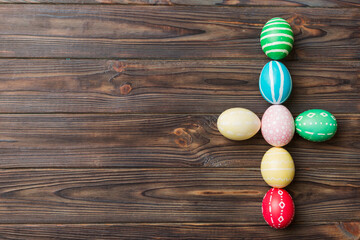 Fototapeta na wymiar holiday preparation Multi colors Easter eggs on colored background, cross show the religious and secular side of Easter. Pastel color Easter eggs. holiday concept with copy space