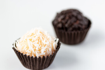 Handmade Brazilian sweets: Beijinho and Brigadeiro. Children's birthday party sweets. macro close - white background