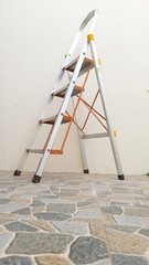 aluminum portable ladders outside of the house. 