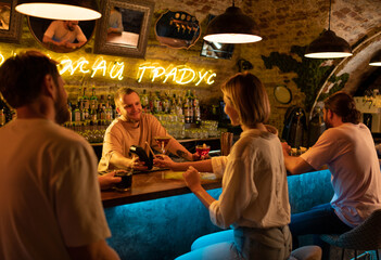 Barman taking payment from woman