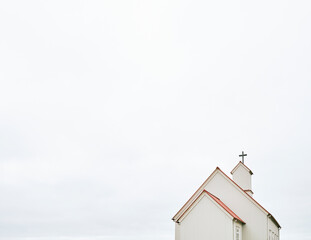 Church exterior with cross on chimney in daylight