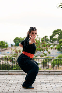 Woman trains kung fu in a park