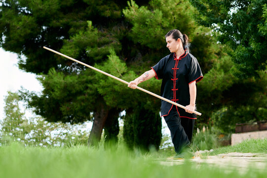 Woman practice kung fu with a stick