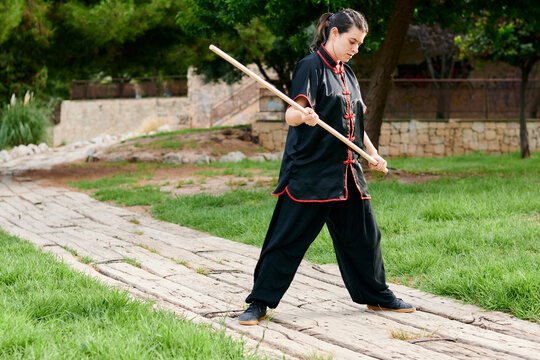 Woman practice kung fu with a stick