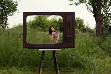 Girl pose in retro tv frame outdoors