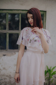 Romantic girl portrait near old house
