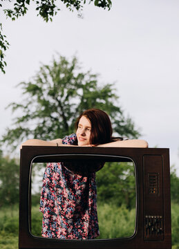 Woman lay at old television frame box