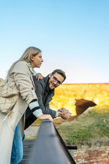 A portrait of a happy romantic couple walking outdoors in the surroundings of an old fortress