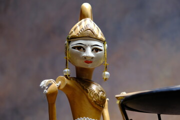 detail of an oriental statuette with typical headdress and intense expression
