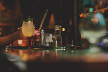 Female barman preparing drinks. cocktail bar Drinks at the bar. Fresh and cold drinks in a bar. Watermelon drink, jamiaca drink, margarita, micheladas.