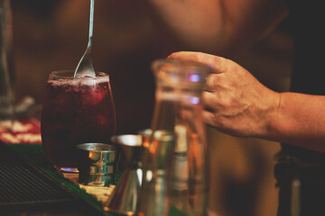 Female barman preparing drinks. cocktail bar Drinks at the bar. Fresh and cold drinks in a bar. Watermelon drink, jamiaca drink, margarita, micheladas.