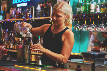 Female barman preparing drinks. cocktail bar Drinks at the bar. Fresh and cold drinks in a bar....