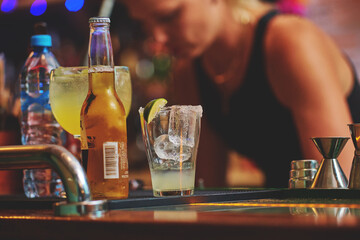 Female barman preparing drinks. cocktail bar Drinks at the bar. Fresh and cold drinks in a bar. Watermelon drink, jamiaca drink, margarita, micheladas.