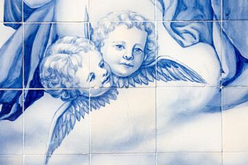 the face of two angels painted in blue azulejos at the monumental stairway to Our Lady of Remedies Sanctuary, Lamego, Viseu, Portugal - obrazy, fototapety, plakaty