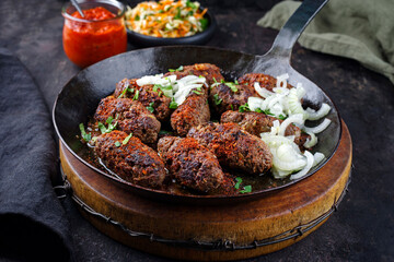 Traditional Croatian cevapi spicy meat ball rolls with cabbage carrot salad and hot ajvar sauce...