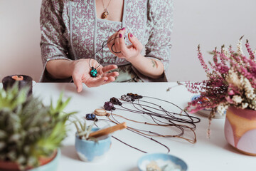 Woman hands making handmade gemstone jewellery, home workshop. Women artisan creates jewellery. Art, hobby, handcraft concept