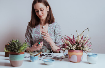 Portrait of artisan woman making handmade gemstone jewellery, home workshop. Women artisan creates jewellery. Art, hobby, handcraft concept
