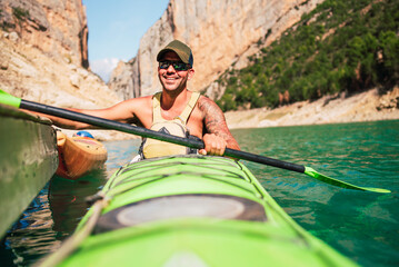 Happy man in his kayak ready to go on a canyon route.