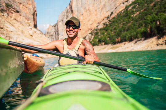 Happy man in his kayak ready to go on a canyon route.