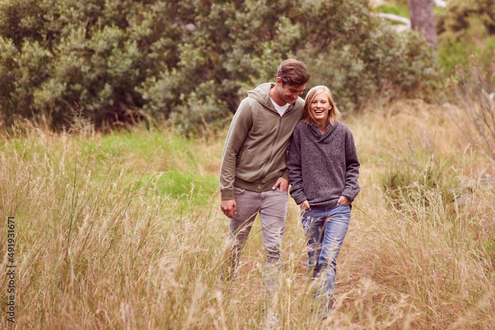 Canvas Prints Marriage can be a walk in the park. A young couple laughing as the walk in a field.