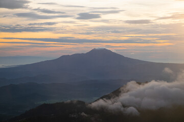 Fototapeta na wymiar colorful sunrise at the highest peak of Mount Si Kunir, Mount Dieng, Wonosobo, Indonesia 