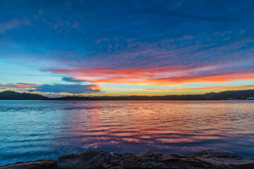 Sunrise by the bay with cumulonimbus clouds