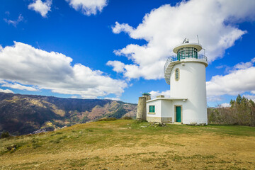 Fototapeta na wymiar Watch tower on the top of the mountain with blue skies, located in the village of Manteigas - Serra da Estrela, Portugal
